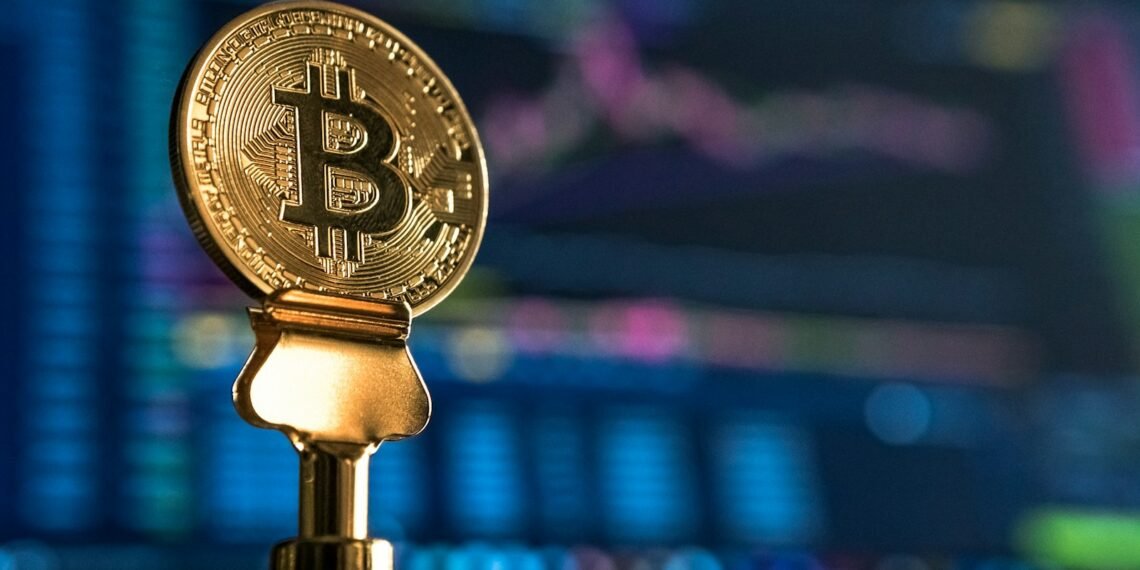 selective focus photo of Bitcoin near monitor
